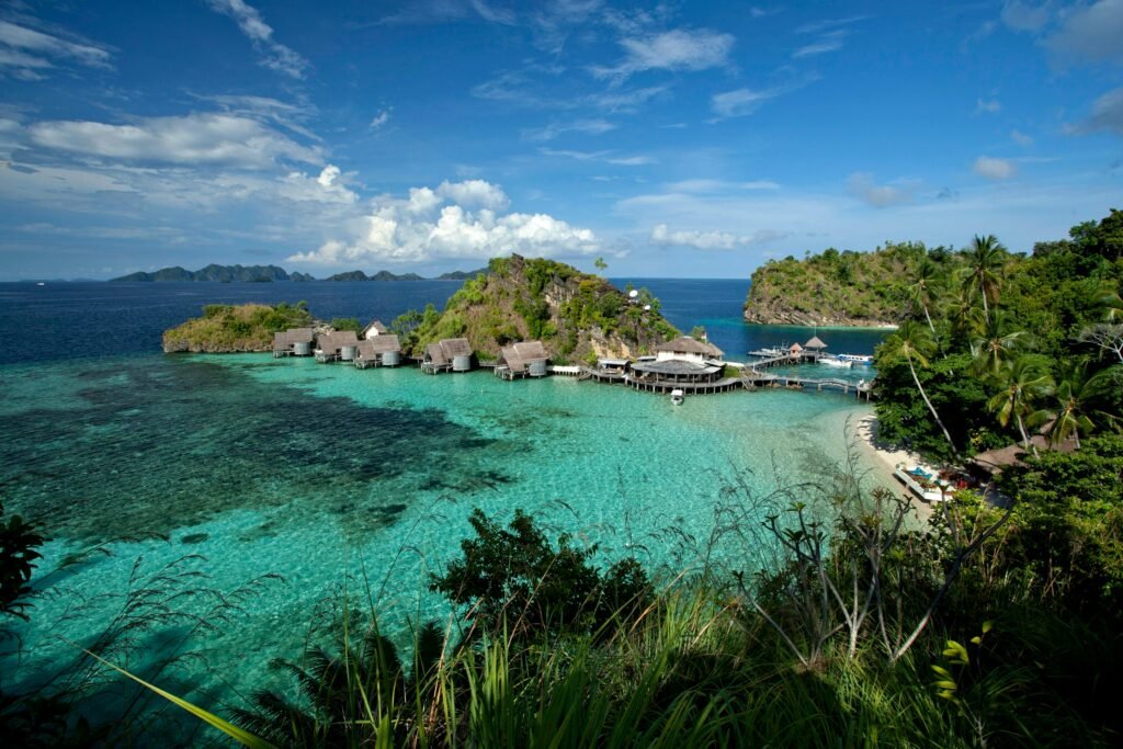 A breathtaking view of Misool Resort's crystal-clear waters and lush islands in West Papua, Indonesia.