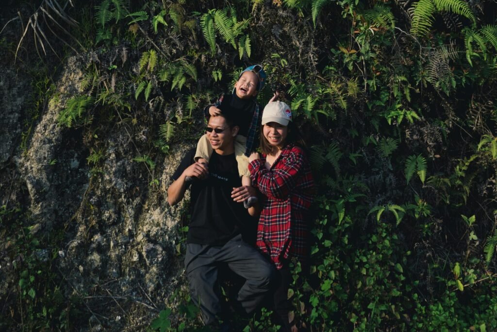 A family of three exploring a lush forest, showcasing togetherness and adventure.