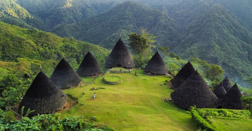 Explore the stunning Wae Rebo Village in Indonesia, nestled in lush mountains.